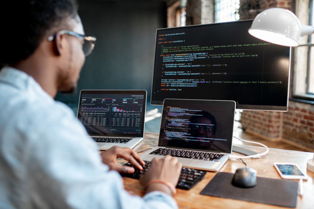 A programmer using Visual Studio Code with popular extensions represented as floating icons.